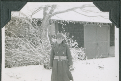 Man standing in snow outside building (ddr-ajah-2-377)