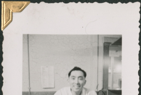Man standing by countertop (ddr-densho-434-149)