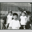 Photograph of children standing in front of the Manzanar hospital (ddr-csujad-47-228)