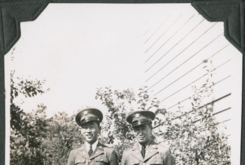Two men in uniform standing on walkway (ddr-ajah-2-130)