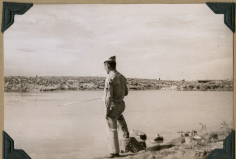 Soldier poses by the water (ddr-densho-397-40)