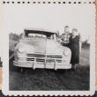 Film strip photo of a couple with a car (ddr-densho-483-438)
