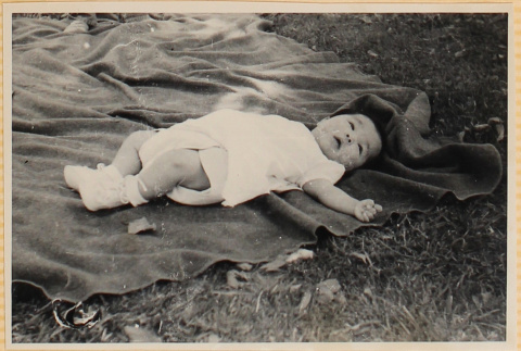 Susan Shiomi laying on blanket (ddr-densho-522-149)
