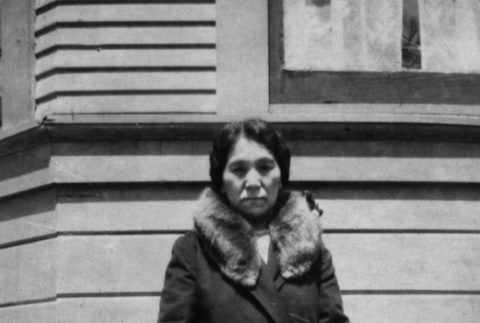 Mrs. Takakura standing outside building (ddr-ajah-6-106)