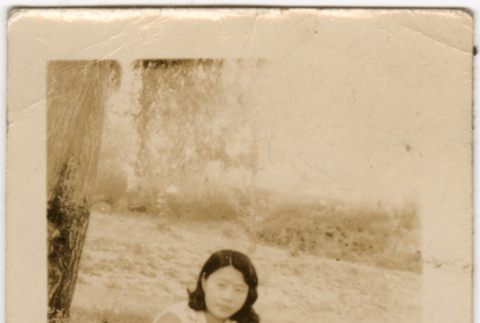 Woman sitting on ground (ddr-densho-523-20)