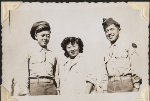 Two men in uniform standing with woman (ddr-densho-466-889)