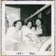 Three women in bed with a baby (ddr-densho-321-273)