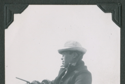 Man holding a fishing pole (ddr-densho-471-24)