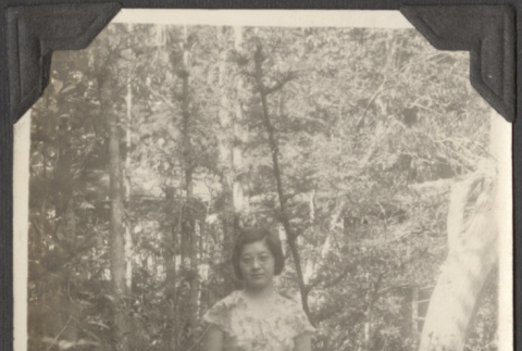 A woman standing in a forest (ddr-densho-432-172)