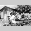 Woman and child in a garden (ddr-densho-2-27)