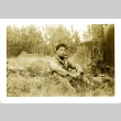 Soldier sitting near tents (ddr-densho-22-209)
