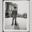 Man standing outside building, cars in background (ddr-densho-434-483)