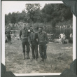 Three men standing by river with men bathing in background.  Joe Iwataki in center (ddr-ajah-2-234)