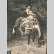 Boy in cowboy gear on bucking horse (ddr-densho-523-244)