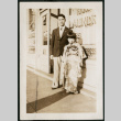 Man and child in front of laundromat (ddr-densho-359-862)