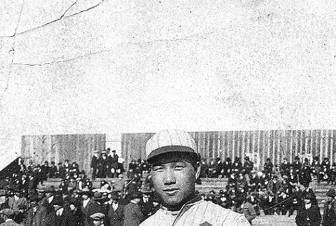 Man in baseball uniform with crowd in background (ddr-ajah-5-65)