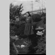 Woman standing in Maneki Garden (ddr-densho-166-4)