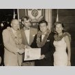 A Honolulu Optimist Club member receiving an award, posing with others (ddr-njpa-2-417)