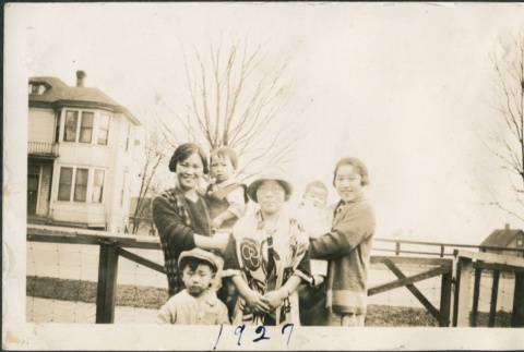 A family in front of a fence (ddr-densho-321-667)