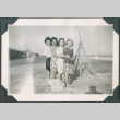 Four women in camp with barracks in background (ddr-densho-483-1100)