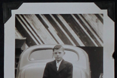Boy in suit poses with car (ddr-densho-359-1432)