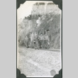 Four men walking along train tracks (ddr-ajah-2-312)