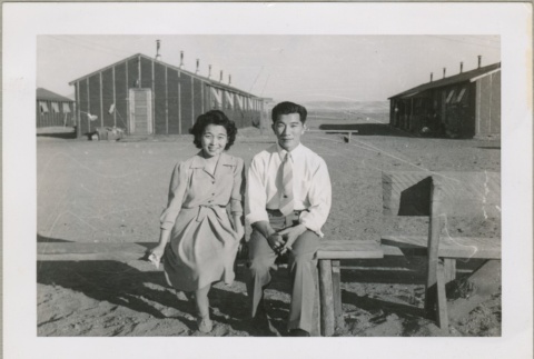 A couple sitting on a bench (ddr-densho-300-14)
