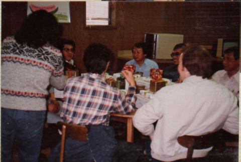 Group of people around a table with presents (ddr-densho-426-1287)