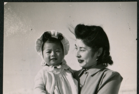 Japanese American woman carries girl toddler with bonnet (ddr-densho-362-49)