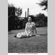 Hatsuyo Ozeki sitting on lawn (ddr-ajah-6-842)