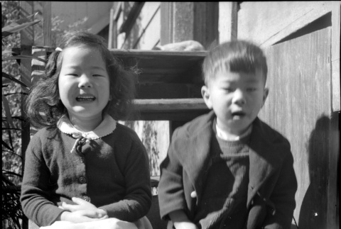 Masako and Norman Takahashi sitting on steps (ddr-densho-426-930)