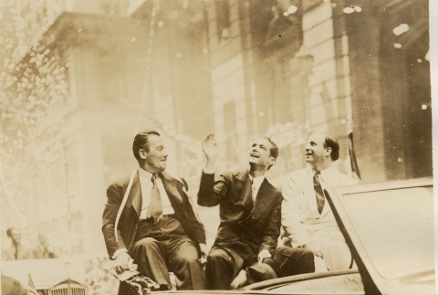 Howard Hughes and two others sitting in a parade car at the New York Worlds Fair (ddr-njpa-1-694)