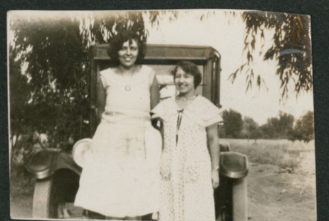 2 women in front of a car (ddr-densho-378-686)