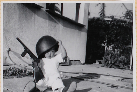 Susan Shiomi playing with toy gun (ddr-densho-522-271)