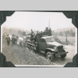 Truck on side of road with group of men in back (ddr-ajah-2-210)