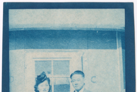 Couple standing outside barracks (ddr-densho-329-1361)