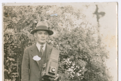 Photo of a man with a camera (ddr-densho-483-60)