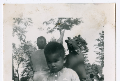 Photo of a child holding a stick (ddr-densho-483-736)