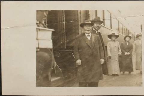 Issei men and women beside a passenger train (ddr-densho-259-271)
