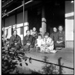 Group of women and children seated in doorway of house (ddr-densho-426-313)