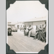 Group of men leaning on a car (ddr-ajah-2-110)