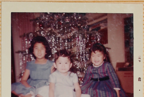 Three girls by Christmas tree (ddr-densho-522-568)