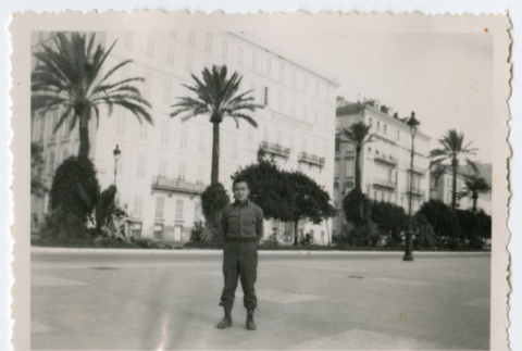 Soldier standing on sidewalk in city (ddr-densho-368-247)