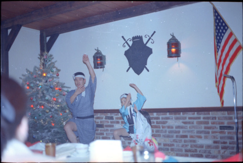 Man and two children performing at party (ddr-densho-426-1173)