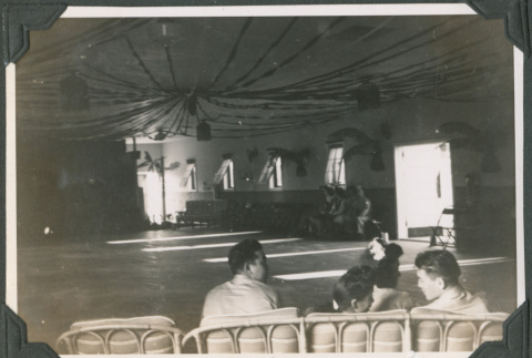 Four people sitting in decorated room (ddr-ajah-2-525)