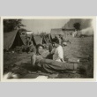 Soldiers lounging on the ground outside tents (ddr-densho-201-186)