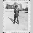 Man standing with large building in background (ddr-densho-434-452)
