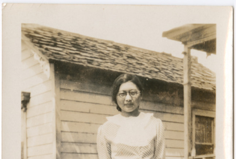 Woman standing in yard outside house (ddr-densho-426-2038)