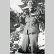Shiro Robert Yamaguchi standing in snow eating from mess kit. (ddr-densho-474-225)