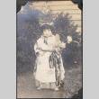 Young girl in costume holding flowers (ddr-densho-493-179)